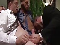 Suit-clad young hunk having sexy threeway fun
