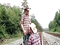 Two naughty guys fuck on a train track